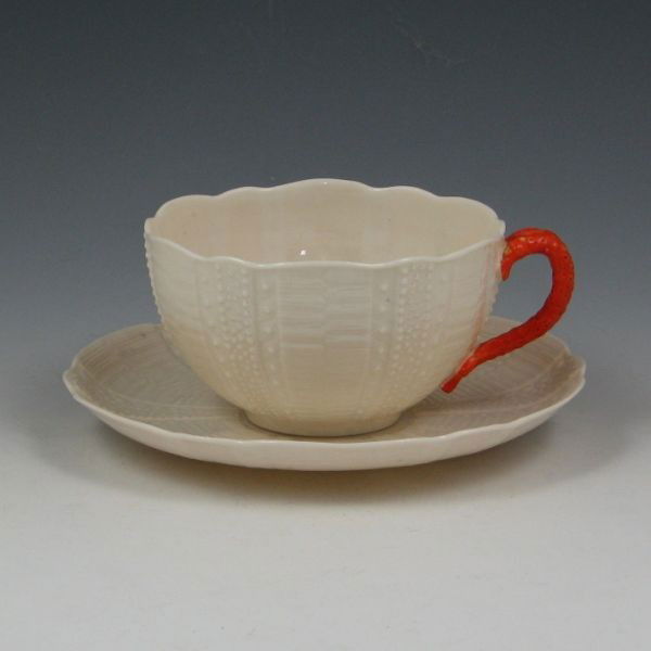 Belleek Echinus Cup & Saucer - 1st Black & Regis.: Belleek Echinus tea cup and saucer with orange handle. Cup is marked with black 1st Mark (1863-1890) and a raised British Registry mark dating to 1869 (H to right). The saucer is unmarked. Excellent c