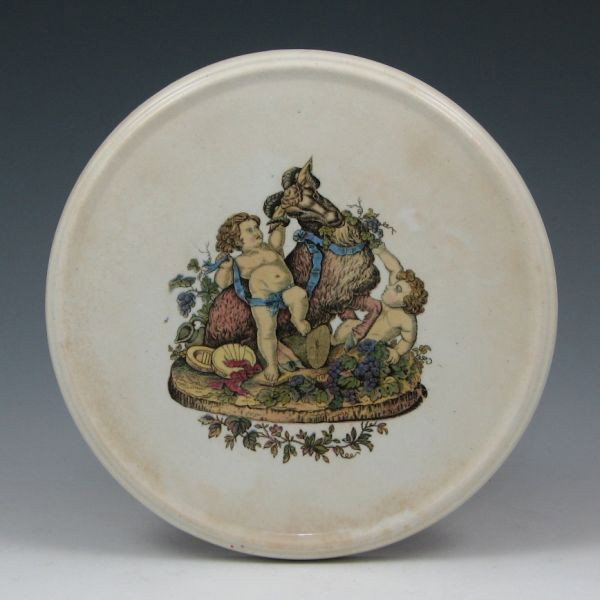 Belleek Bacchanalian Trivet - 1st Black: Belleek earthenware trivet with Bacchanalian transfer ware. Marked with black 1st Mark (1863-1890). No chips or damage, but there there is light scratching to the finish. 7" in diameter.