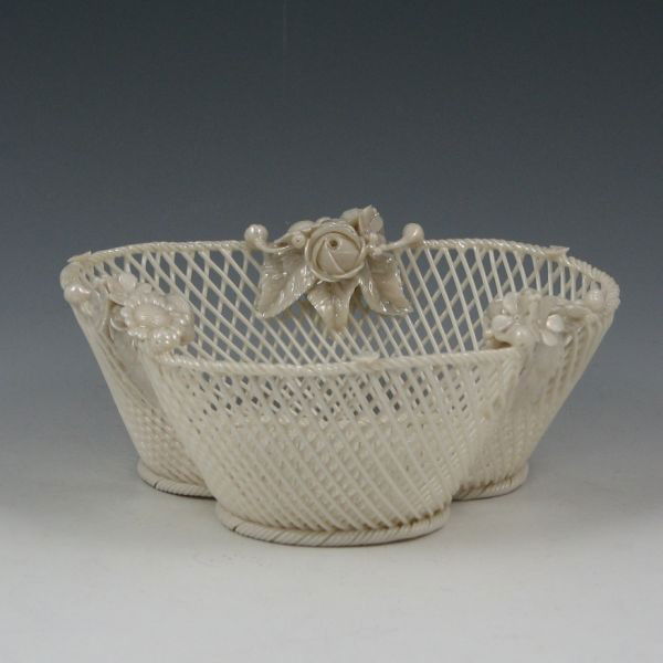 Belleek Three-Strand Basket (1890-1920): Belleek three-strand lobed basket with applied floral decoration. Marked Belleek Co. Fermanagh on a single pad (circa 1890-1920). Mint. 6 1/4" wide by 2 3/4" tall.