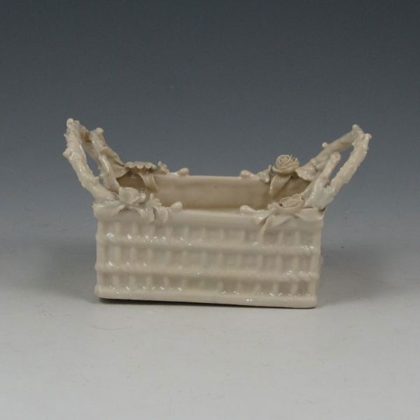 Belleek Flowered Crate - 2nd Black: Belleek Flowered Crate. Marked with black 2nd Mark (1891-1926). The entire piece has been oversprayed with what appears to be damage to the basket and one handle having been restored. 4 5/8" wide by 2