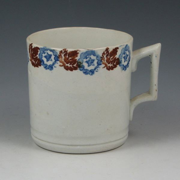 Belleek Earthenware Mug - 2nd Black: Belleek earthenware mug with blue and brown stencil underglaze decoration. Marked with black 2nd Mark (1891-1926). Bruise to rim. 3 3/4" tall.