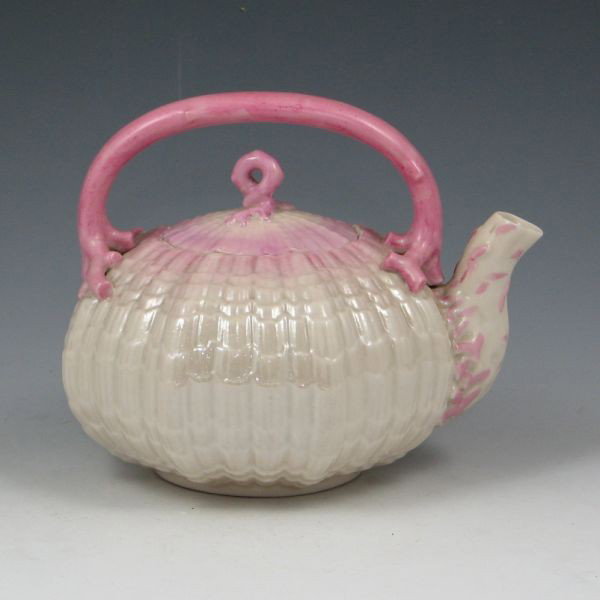 Belleek Tridacna Tea Kettle - 2nd Black: Belleek Tridacna tea kettle with pink tint. Marked with black 2nd Mark (1891-1926). The body is mint while the lid has been broken and professionally restored. 6 1/4" wide by 5 1/8" tall.
