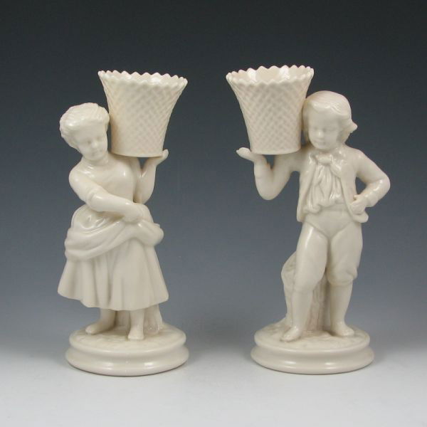 Belleek Boy & Girl Basket Carriers - 6th Green: Belleek Boy and Girl Basket Carriers. Both are marked with green 6th Marks (1965-1981). Both mint. 8 1/4" tall.