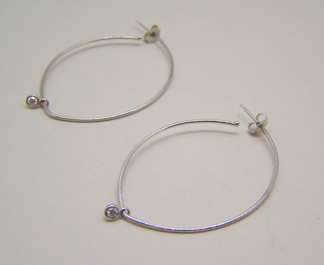 14k gold modernist .20Ct Vs G diamond hoop earrings: measures 2 1/16" long by 1 5/16" wide, crafted with 1 .10 Ct VS1 E/G white diamond, weights 3 grams, marked 14k, in great condition