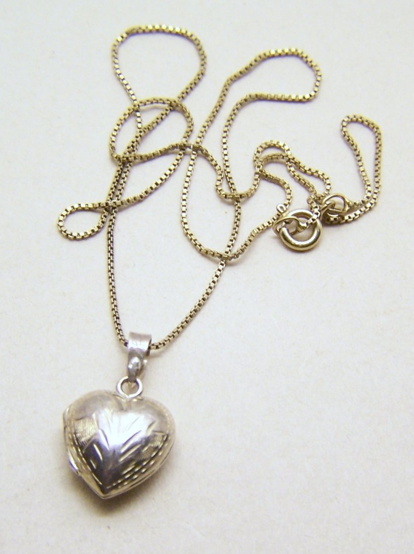sterling silver heart locket pendant chain necklace: pendant measures 15/16" long by 9/16" wide, chain measures 18 3/16" long, weights 4.4 grams, in great condition may need to be cleaned.