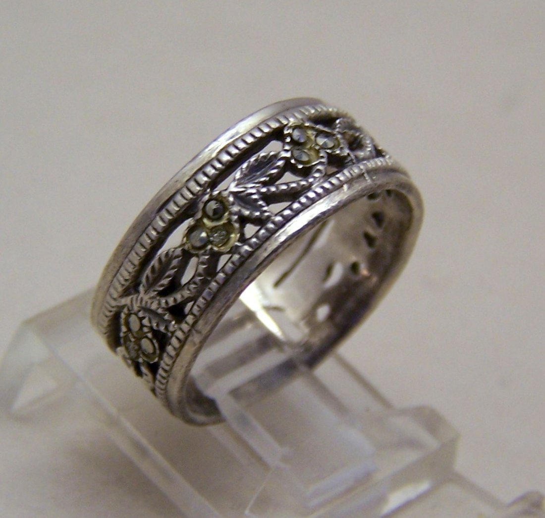 signed sterling silver marcasite band ring: measures 5/16" wide, weights 3.8 grams, marked 925, size 5 1/2 but can be re-size.
