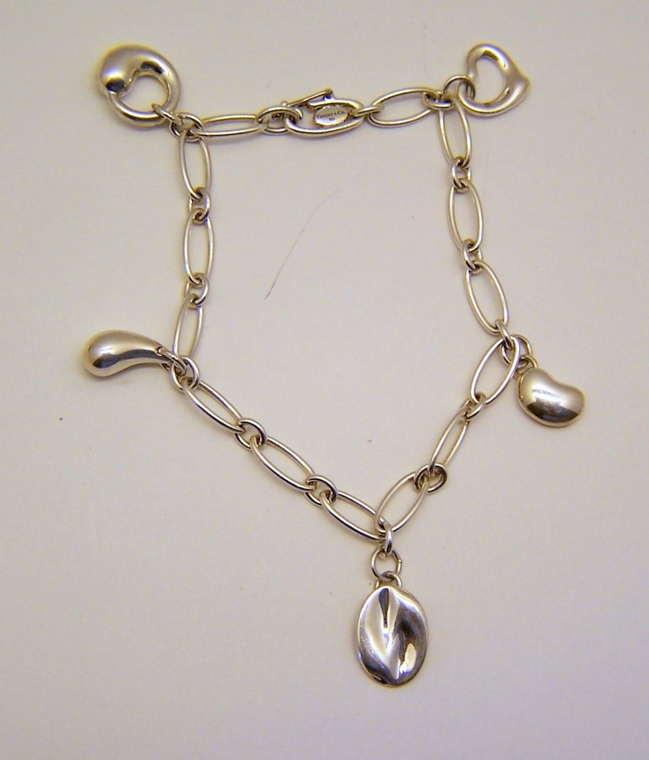 ELSA PERETTI TIFFANY & Co sterling charm bracelet: measures 7 1/16" long, the large charm measures 1/2" long , weights 11.45 grams, signed Elsa Peretti Spain Tiffany & co 925 & 1 of the charms is signed Piscis Tiffany & Co. Elsa Peretti 925 spain , in