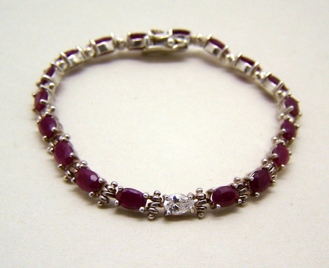 DBJ sterling silver ruby sapphire tennis bracelet: measures 7" long by 3/16" wide, crafted with 5x3mm genuine ruby & 6x4mm pear shape sapphire, weights 12.1 grams, marked 925 DBJ, in great condition