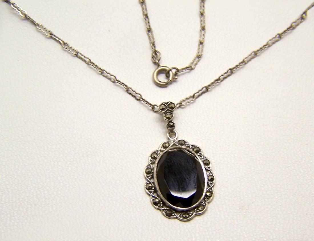 Art Deco sterling silver onyx marcasite necklace: pendant measures 1 3/16" long by 11/16" wide crafted with 15x11mm onyx, the chain measures 17 15/16" long, weights 6 grams, marked ster, in great condition
