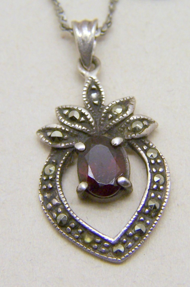 sterling silver marcasite garnet pendant necklace: pendant measures 1 1/8" long by 9/16" wide, crafted with 7x5mm garnet & marcasite, chain measures 16" long, in great condition