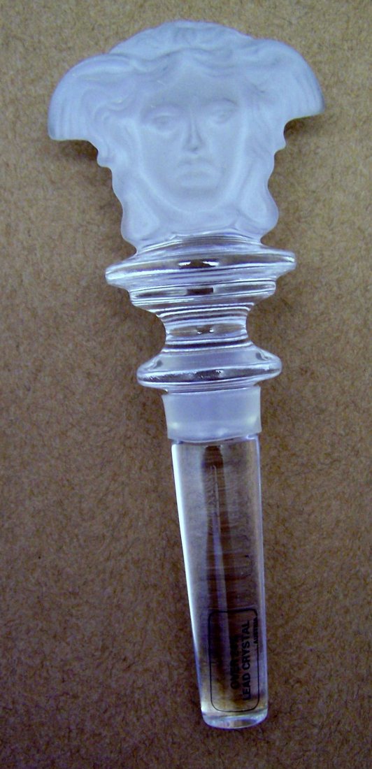 Rosenthal Versace medusa crystal bottle stopper: measures 5 1/2" long by 2 1/2" wide signed over 24% lead crystal Rosenthal Versace, in like brand new condition with our box.