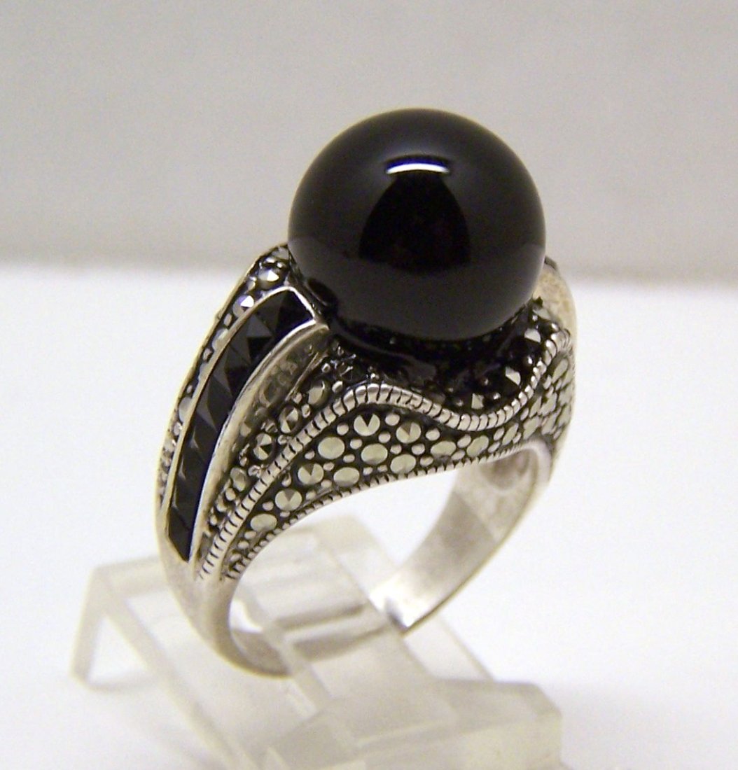 sterling silver marcasite onyx ring: top of the ring measures 13/16" long by 5/8" wide, crafted with marcasite & 12mm onyx, weights 11.22 grams, size 7, signed A 925, in great condition