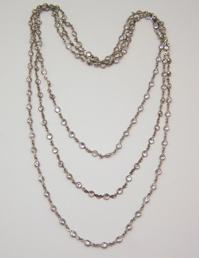 sterling silver 60" Cz "diamond by the yard" necklace: measures approximately 60" long, crafted with 3mm round Cz set in sterling silver bezel setting, weights 25.48 grams, signed 925, in great condition