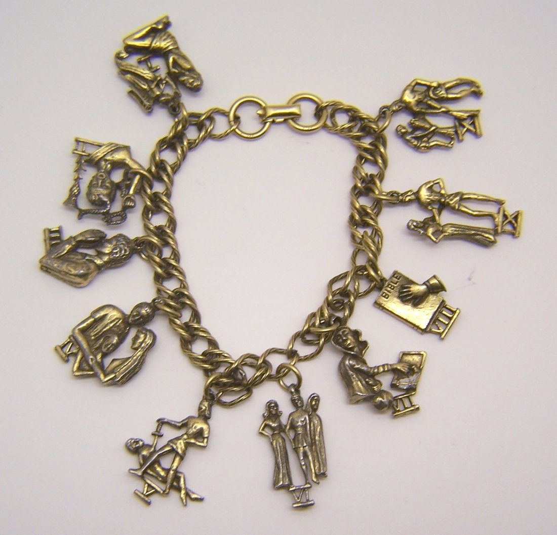 vintage CORO the 10 commandments charm bracelet: measures 7 1/2" long, crafted with 1 3/16" long to 1 1/4" long charms, weights 45 grams, signed Coro, in good condition.