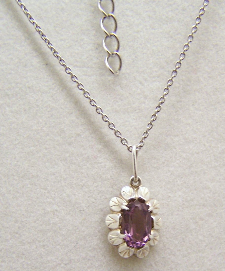 sterling silver alexandrite necklace: pendant measures 6/8" long by 3/8" wide, crafted with 7x4mm alexandrite, the chain measures 17 3/4" long, weights 2.57 grams, signed 925, in great condition