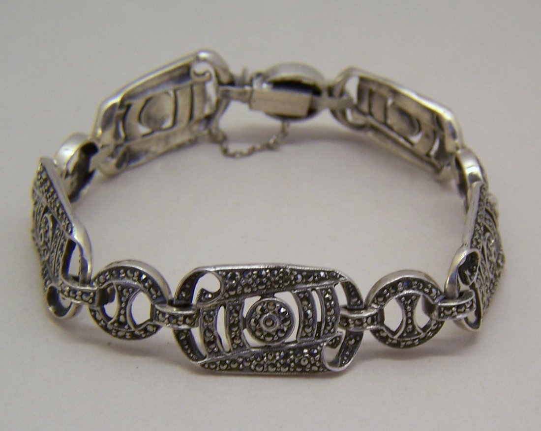 Art Deco sterling silver marcasite bracelet: measures 7 3/8" long by 5/16" wide, crafted with marcasites, weights 28 grams, marked 925, in good condition.