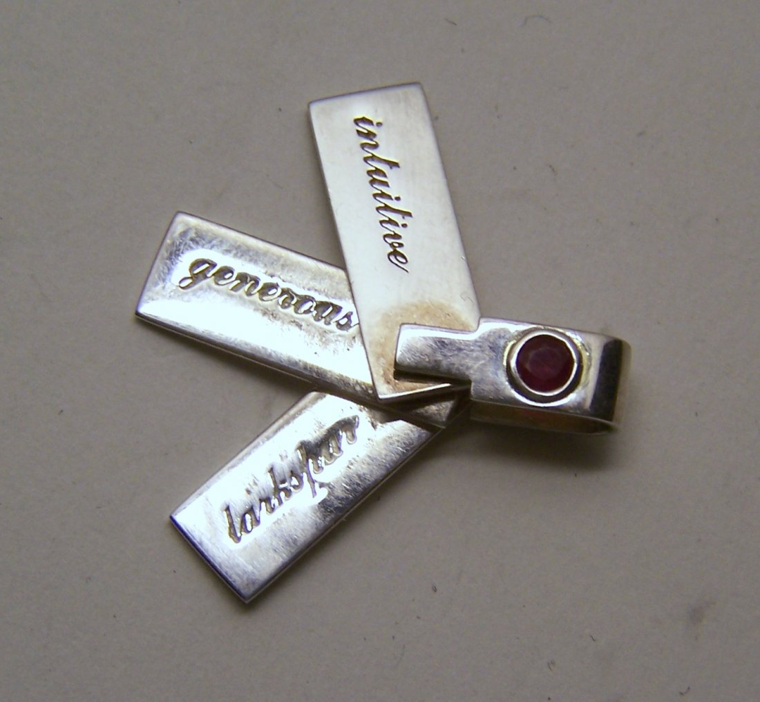 sterling ruby Intuitive Generous larkspur pendant: measures 1 1/4" long by 5/16" wide when is close, weights 6.16 grams, marked 925, in good condition, crafted with a 4mm ruby