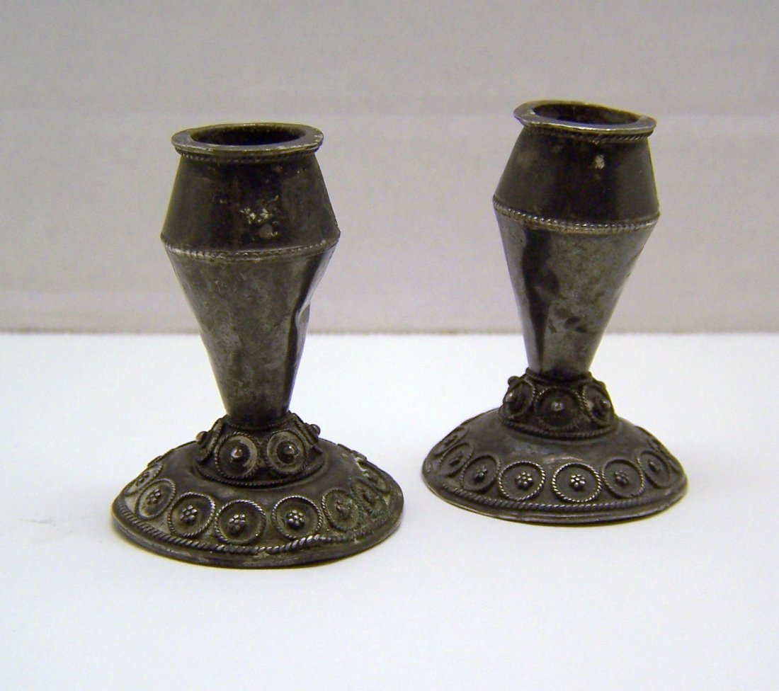 Antique pair of sterling silver shabbat candle holders: each candle holder measures 2" tall by 1 1/2" wide, they are unsigned but tested as sterling silver, weights 35.58 grams, they are in fair condition some bends on the base, need to be polish, check pi