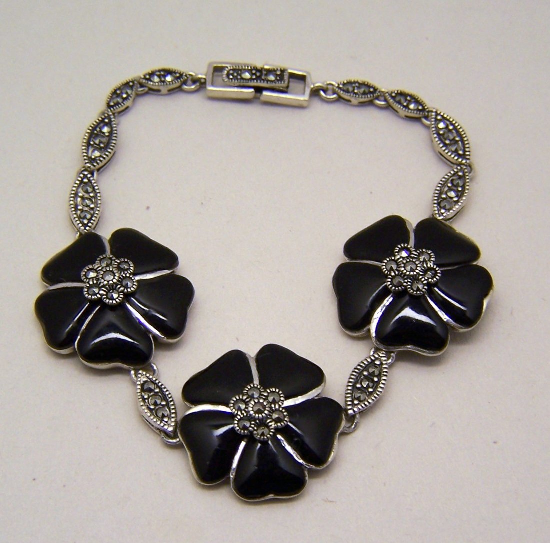sterling silver marcasite onyx flower bracelet: bracelet measures 7 5/8" long by 7/8" wide, crafted with marcasites & onyx on the petals, weights 22 grams, marked 925 K Thai. in great condition.