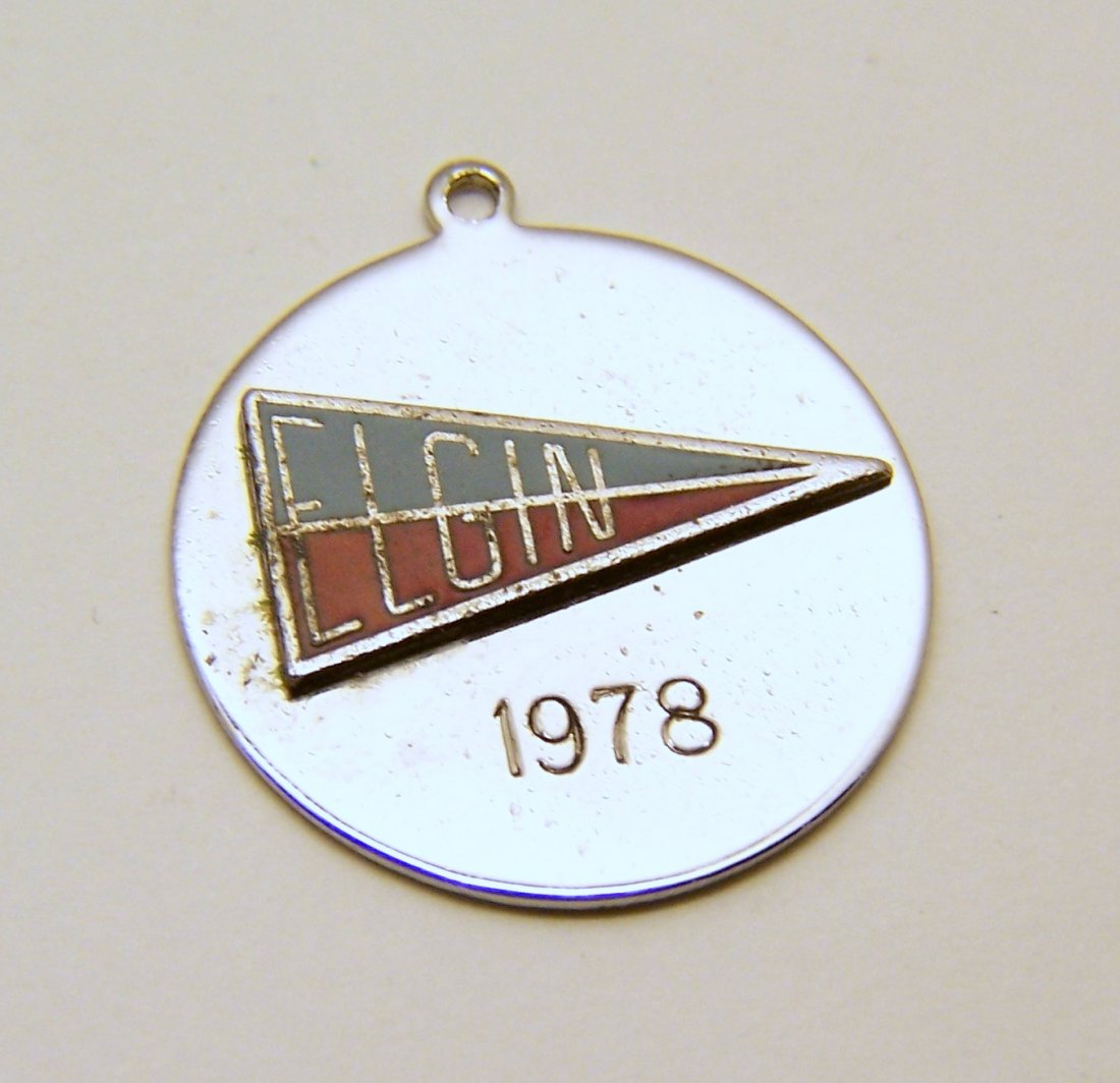 Elgin local schools sterling silver charm: measures 1 1/16" long by 15/16" wide, weights 4.89 grams, signed Sterling silver Elco, Best wishes Elgin local schools, in great condition.