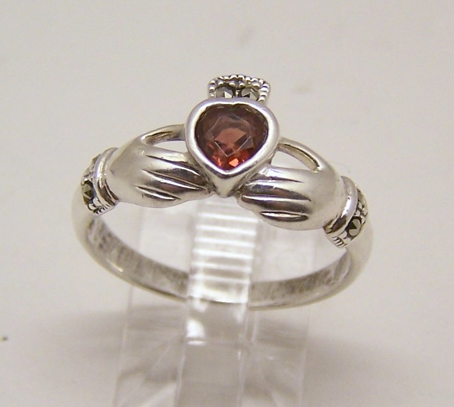 sterling silver garnet marcasite claddagh ring: top of the ring measures 7/16" wide, crafted with 5x5mm garnet, size 9 1/2, weights 3.08 grams, signed 925, in great condition