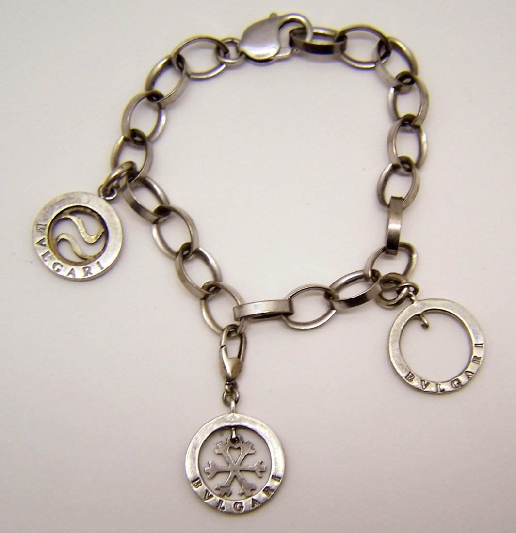 sterling silver designer signed charm bracelet: measures 7 1/2" long, crafted with 1 1/16" long to 1 3/8" long charms (note one of the charms have missing the center), weights 24.55 grams, signed bvlgari 925, in good condition I found this bracelet