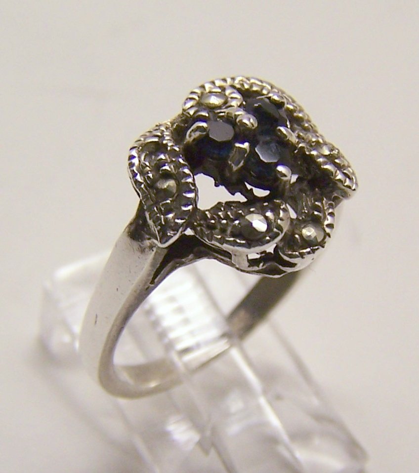 sterling silver marcasite sapphire ring: top of the ring measures 9/16" wide, crafted 3mm sapphire & marcasites ( note 1 marcasite is missing). size 8 1/2, weights 4.38 grams, marked 925, in good condition