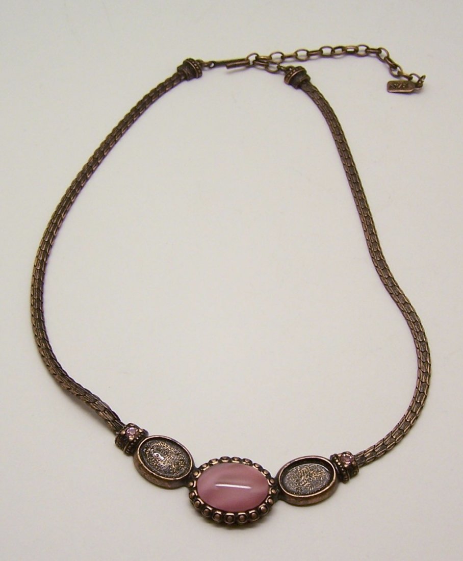1928 copper cat eye rhinestone necklace: measures 19" long, crafted with a glass cat eye & rhinestones ( 2 of the cabochons are missing), weights 29.74 grams, in good condition