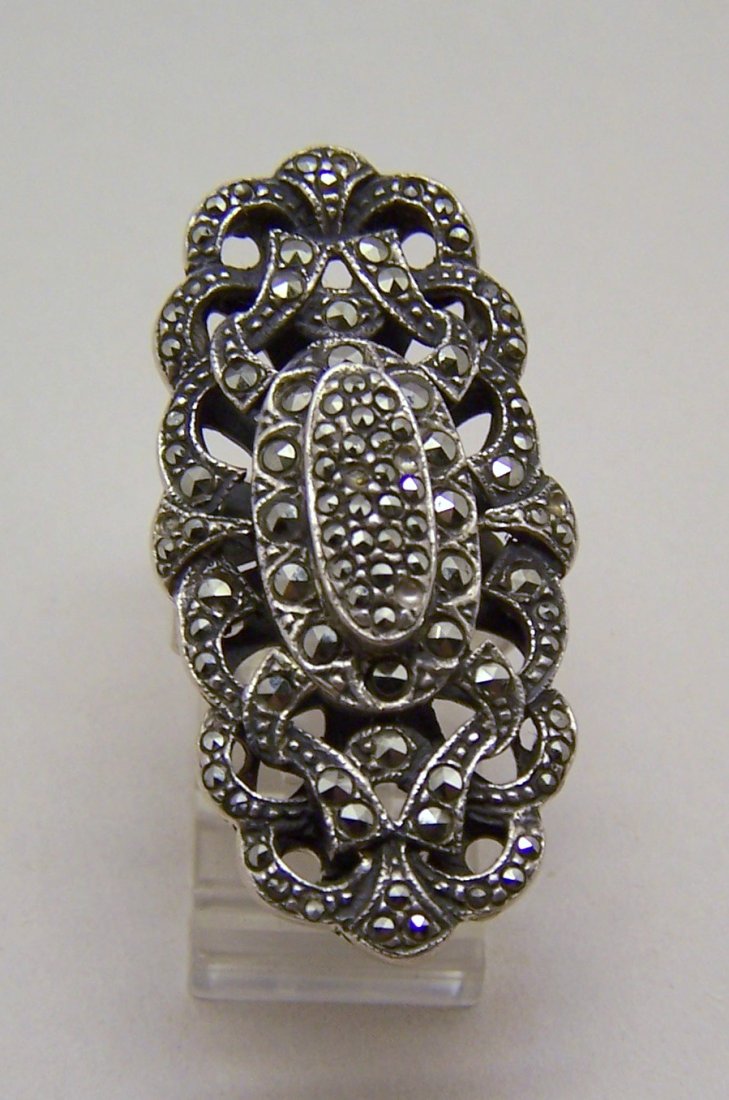 huge Art nouveau sterling silver marcasite ring: top of the ring measures 7/8" long by 1 6/8" wide, crafted with marcasite btw 2-5 small marcasites are missing, weights 14.2 grams, size 5 3/4, marked 925, in great condition, we have a bracelet the w