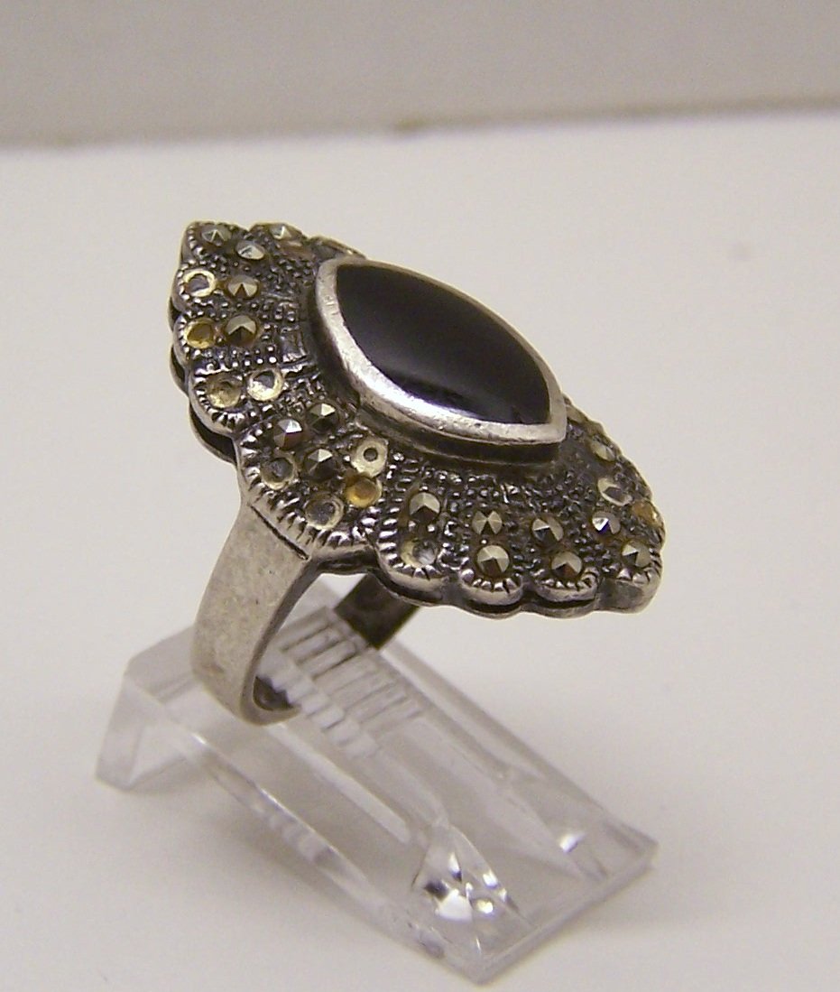 vintage sterling silver marcasite onyx ring: top of the ring measures 1 3/16" wide, size 6 1/2 but you can re-size it, weights 6.11 grams, signed sterling , in good condition but need to be replace most of the marcasite