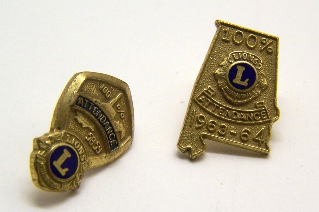set of 2 100% attendance Lions international pin: each pin measures apron 11/16" long, in good condition missing the back screw.