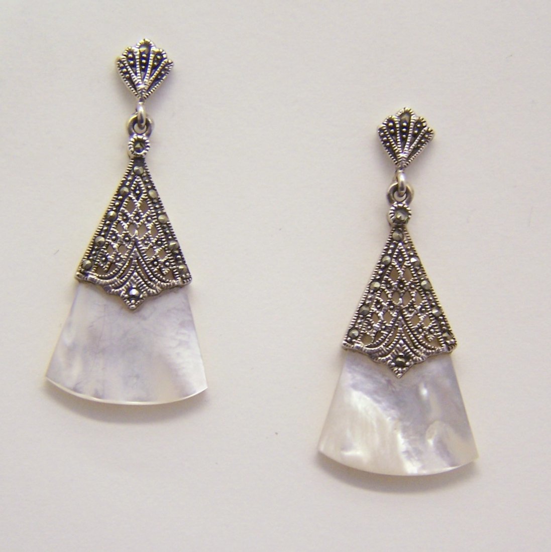 sterling silver mother pearl marcasite earrings: measures 1 5/8" long by 6/8" wide, weights 7.21 grams, in great conditin