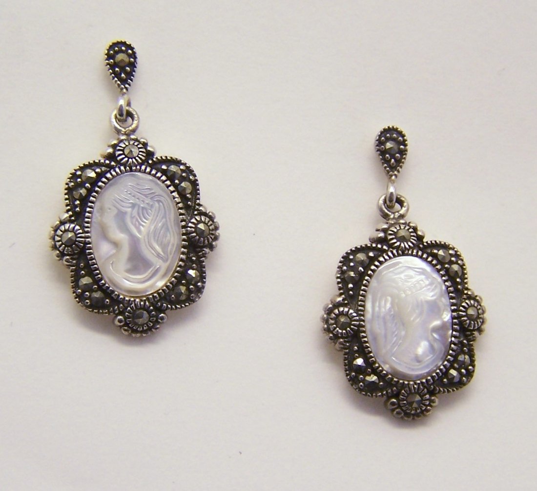sterling mother pearl cameo marcasite earrings: measures 1 5/16" long by 6/8" wide, crafted with 13x10mm carved cameo mother of pearl & marcasites