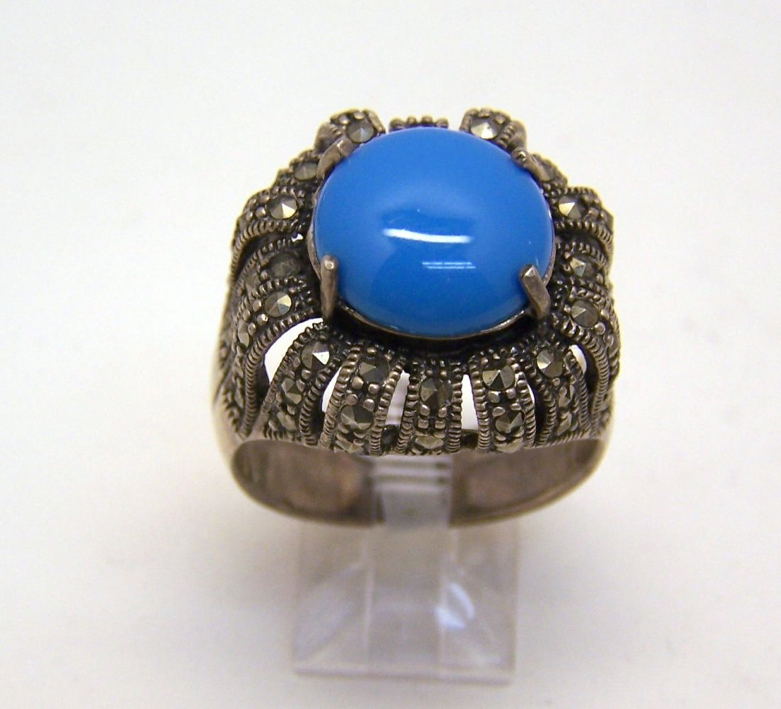 sterling silver turquoise marcasite ring: top of the ring measures 7/8" wide, cradyed with 13mm faux turquoise & marcasite, size 11 1/4, weights 11 grams, in great condition