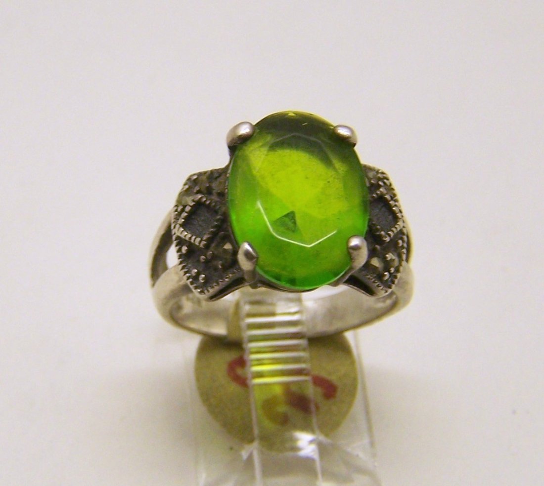 vintage sterling silver peridot marcasite ring: top of the ring measures 9/16" wide, crafted with 13x10mm peridot, size 5 1/2, weights 4.26 grams, good condition