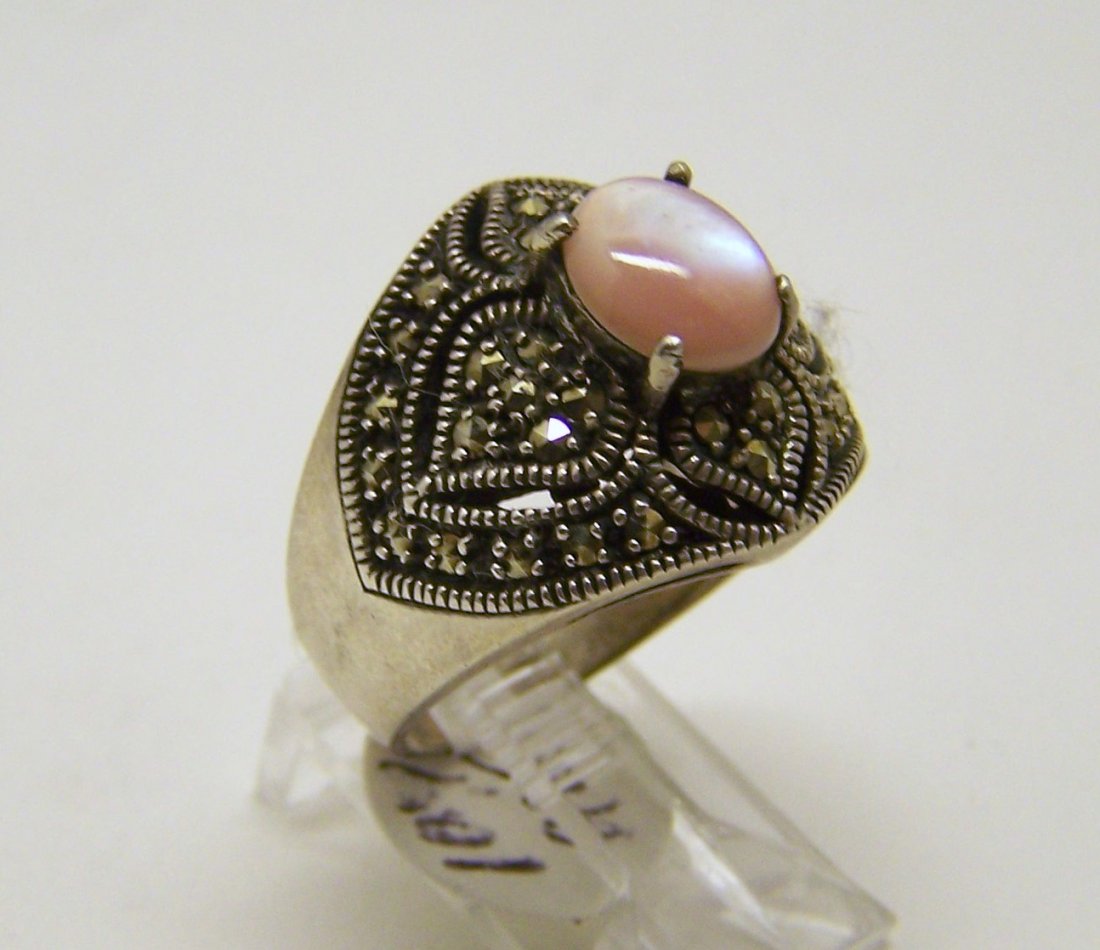 vintage sterling silver mother pearl marcasite ring: top of the ring measures 6/8" wide, crafted with 8x7mm mother pearl, size 7 1/2, weights 10.4 grams, good condition