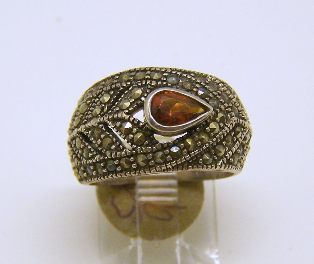 sterling silver marcasite garnet ring: top of the ring measures 1/2" wide, crafted with 6x4mm garnet, size 5, weights 5.8 grams, in good condition