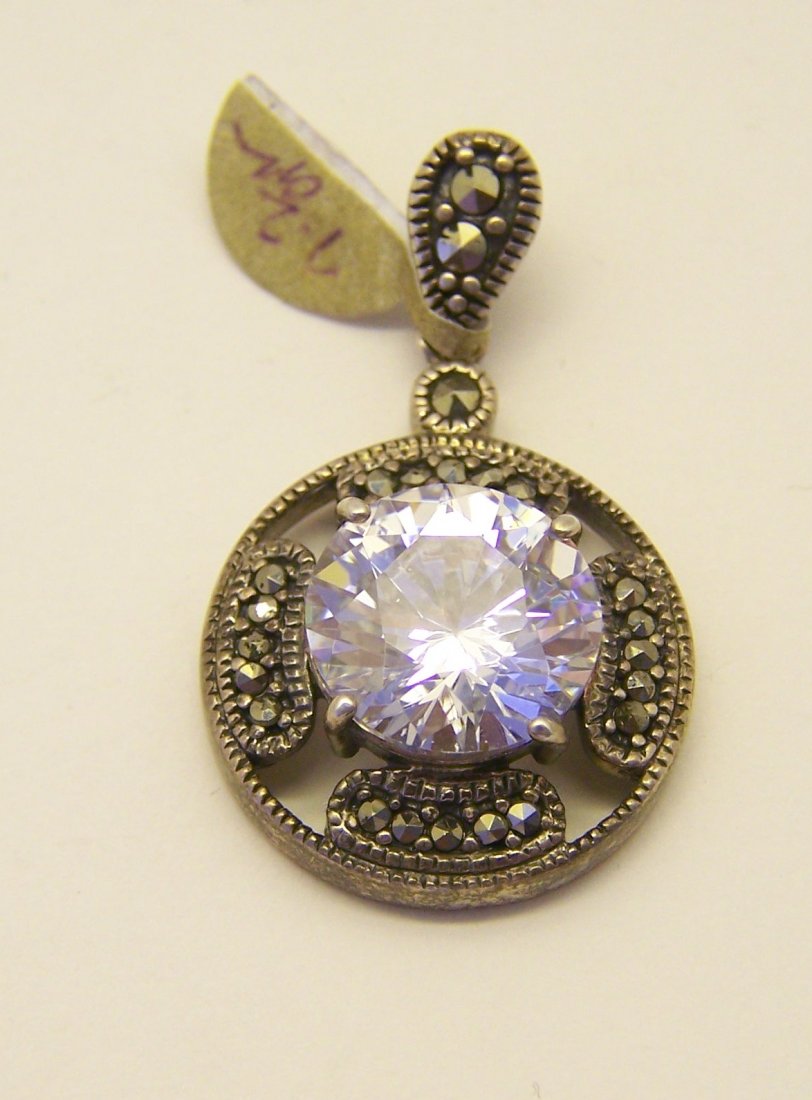 sterling silver Cz marcasite pendant: measures 1 3/8" long by 13/16" wide, crafted with 12mm cz, weights 7.2 grams, in good condition