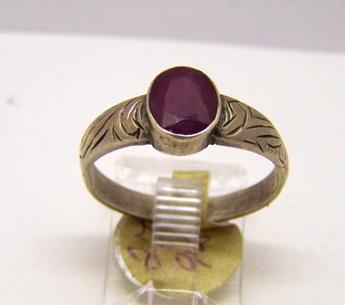 Vintage sterling silver ruby ring: top of the ring measures 5/16" wide, crafted with a 7x5mm ruby, size 7 3/4, weights 2.7 grams, in good condition