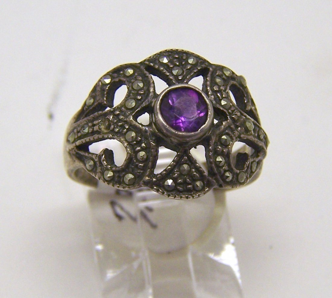 sterling silver marcasite amethyst ring: top of the ring measures 9/16" wide, crafted with a 4mm amethys & marcasites, size 6, weights 3.7 grams, in good condition