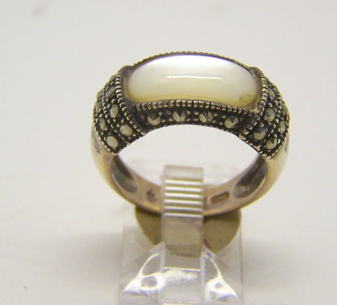 sterling silver mother of pearl marcasite ring: top of the ring measures 3/8" wide, crafted with 14x6mm mother of pearl & marcasites, size 7, weights 5.3 grams, in good condition