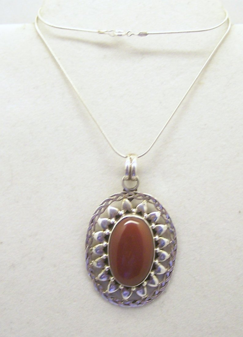 sterling silver carnelian pendant necklace: measures 16 3/8" long, crafted with 2 7/16" long the hold 27x17mm carnelian pendant , weights 20.4 grams, in good condition