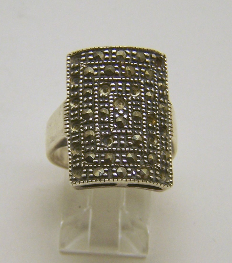 sterling silver marcasite ring: top of the ring measures 13/16" wide, crafted with marcasite few of them missing, size 7, weights 7.25 grams, in good condition