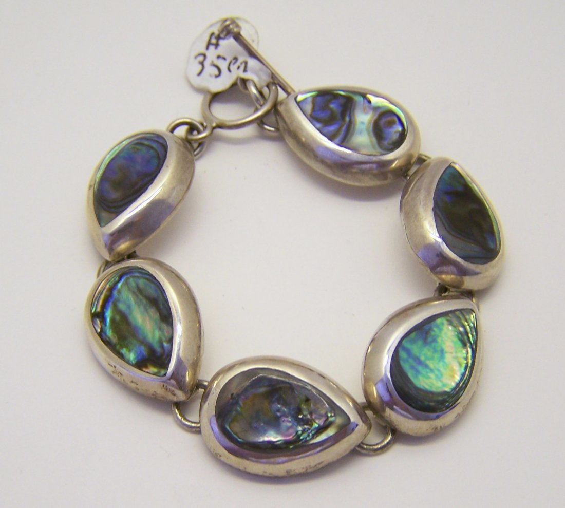 Mexican sterling silver abalone bracelet: measures 7 1/8" long by 11/16" wide, crafted with abalone inlay, weights 51 grams, in good condition