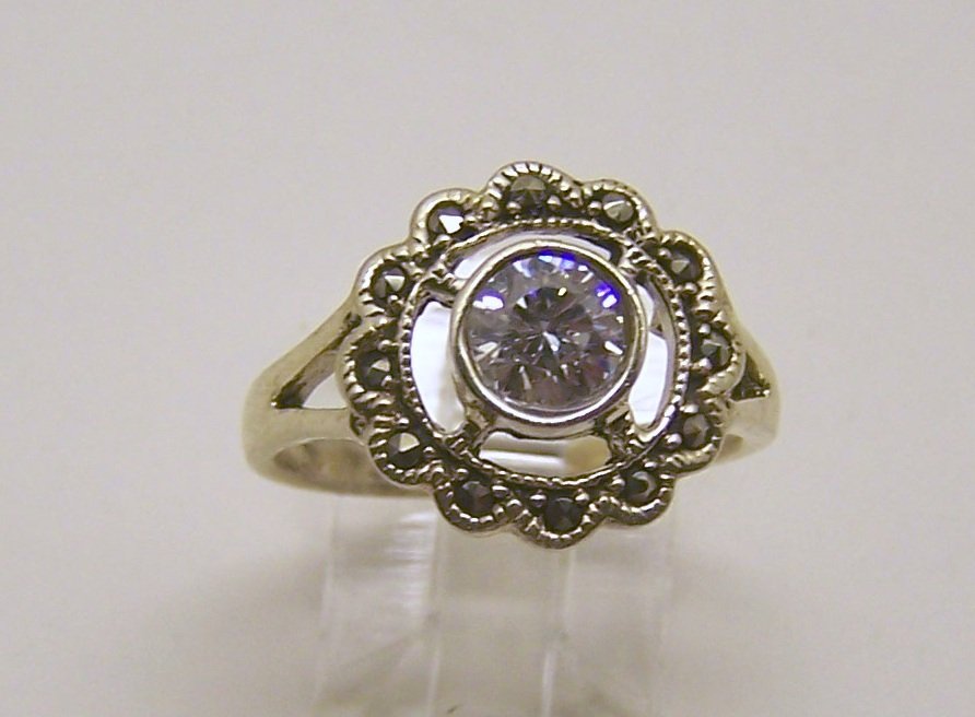 sterling silver Cz marcasite ring: top of the ring measures 9/16" wide, crafted with 6mm cz, size 7 3/4, weights 4.4 grams, in good condition