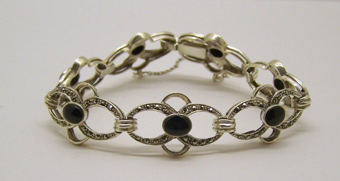vintage sterling silver onyx marcasite bracelet: measures 7" long by 5/8" wide, crafted with 7x5mm onyx & marcasite, weights 18.9 grams, in good condition