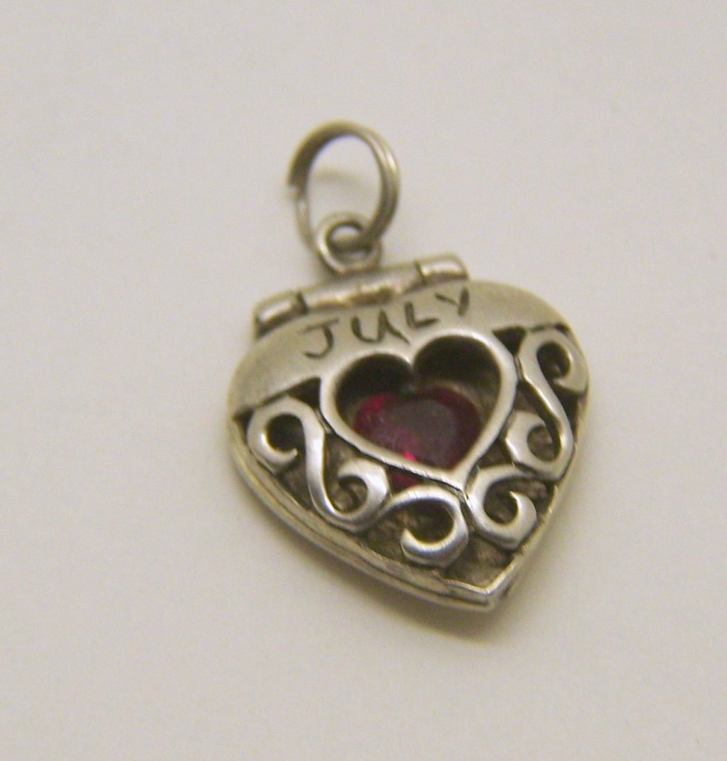JULY ruby cz sterling silver pendant: measures 7/8" long by 9/16" wide, crafted with 5x5mm ruby cz, weights 2.8 grams, in good condition