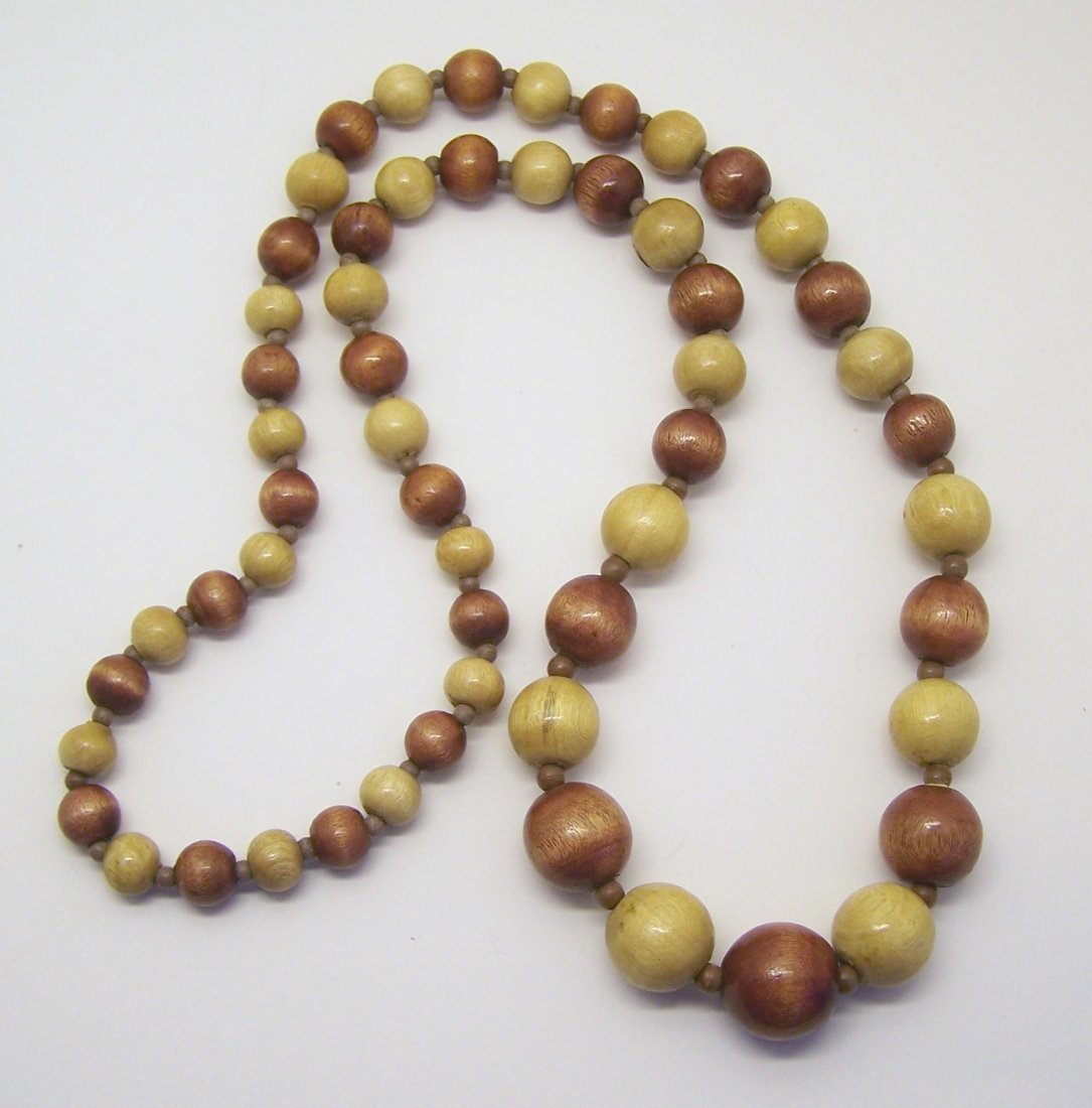 graduated wood bead necklace: measures 30" long, crafted with 10mm to 19mm wood beads, weights 55 grams, in great condition