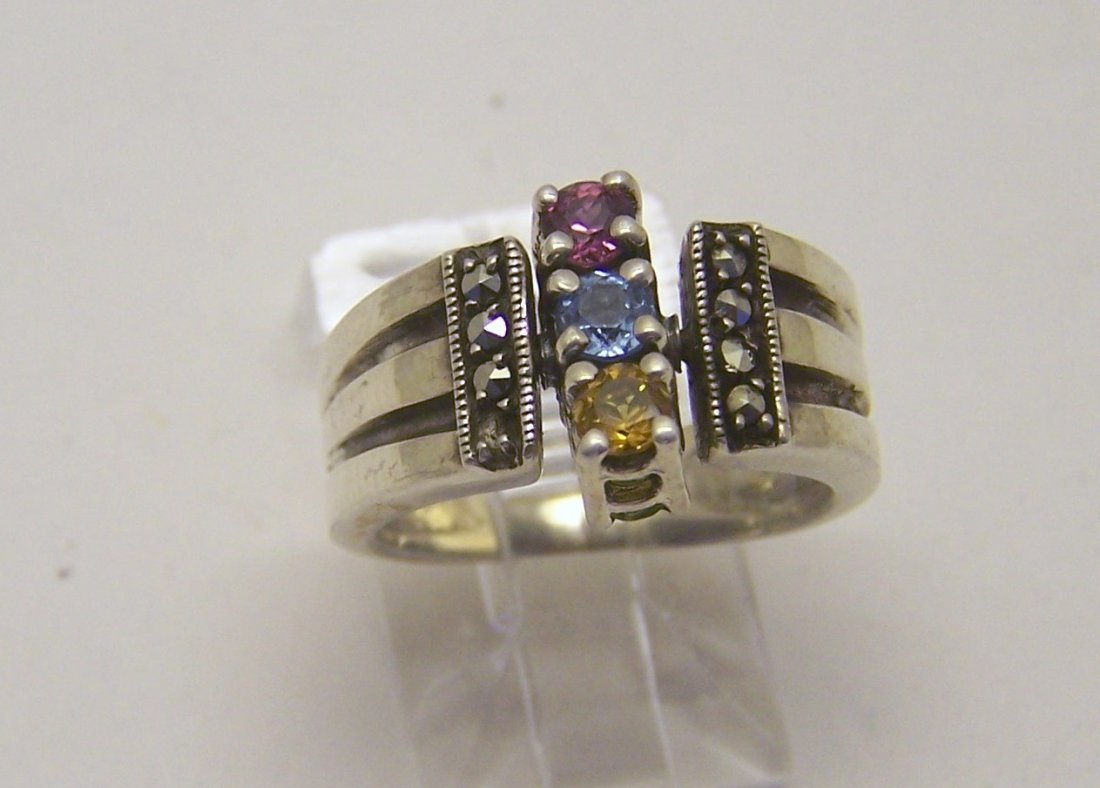 sterling silver marcasite swivel ring: top of the ring measures 7/16" wide, crafted with citrine, blue topaz, ruby, amethts & peridot, size 5, weights 5.6 grams, in great condition