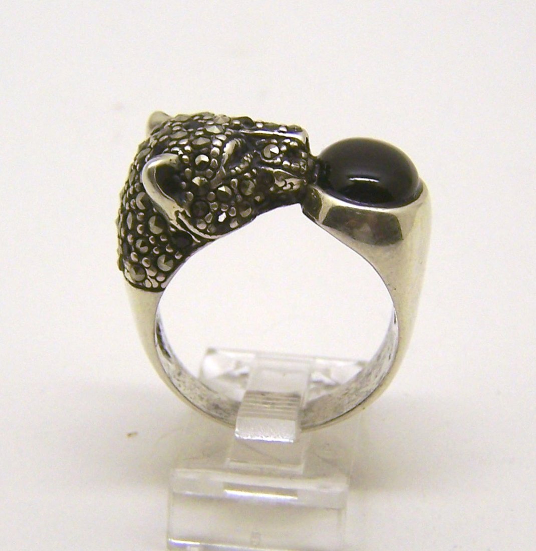 GA sterling silver onyx marcasite ring: top of the ring measures 1/2" long, size 8 1/2, crafted with 10x8mm onyx, 1 emerald is missing , weights 8.9 grams, in good condition